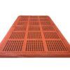 The Interlocking Catering Mat is a large rectangular orange mat with a grid pattern of raised dots, designed to assist visually impaired pedestrians.