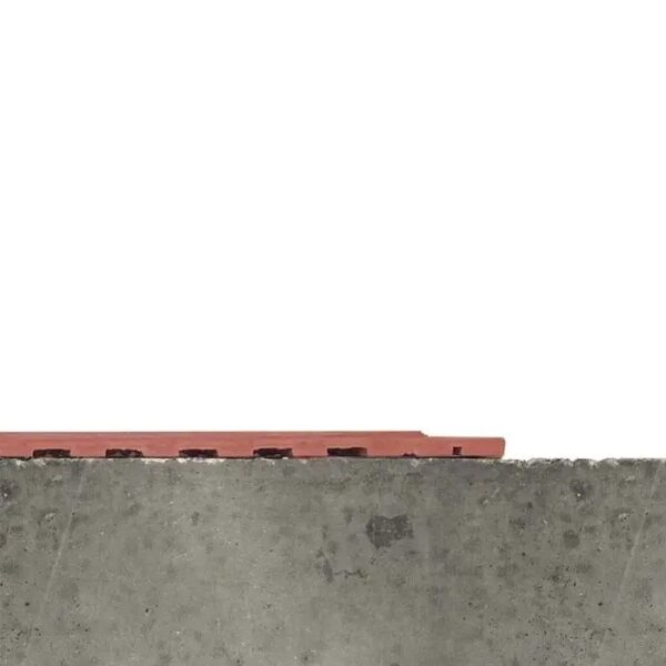 A close-up of a concrete surface features the Interlocking Catering Mat, a red, rectangular object partially visible against a plain white background.