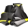 A pile of rolled-up Standard Anti-Fatigue Mats in black and grey, some secured with yellow bands, arranged against a plain white background.