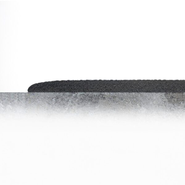 A close-up of the Standard Anti-Fatigue Mat’s textured black surface, partially visible behind a rough, grey, stone-like layer against a plain white background.