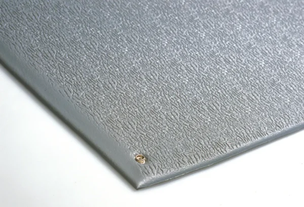 A close-up of the Anti-Static Mat, featuring a textured grey surface and a small metal eyelet in one corner, shown on a white background.
