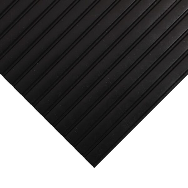 A close-up of the Interlocking Bubble Top Stable Mat, black with diagonal grooved lines, is shown on a white background with a pointed corner facing the bottom right-hand side.