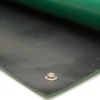 Close-up of Conductive Rubber Bench Matting in black, featuring a metal eyelet on one edge, displayed on a white surface and partially covered by a green layer.