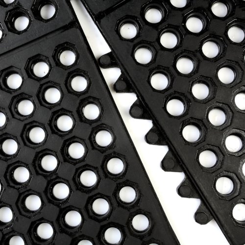 Close-up of two Interlocking Anti-Fatigue Mats in black rubber, featuring hexagonal holes and interlocking edges, arranged diagonally on a white background.