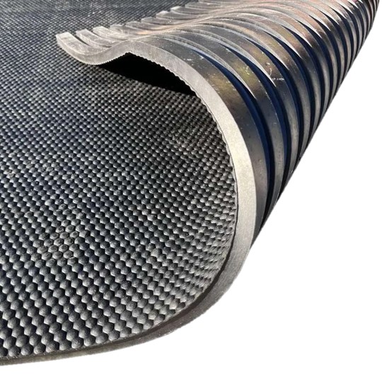 Close-up of the Cobble Top Stable Mat, featuring a black rubber, textured non-slip surface. One corner is curled up to show the ridged underside for extra grip.