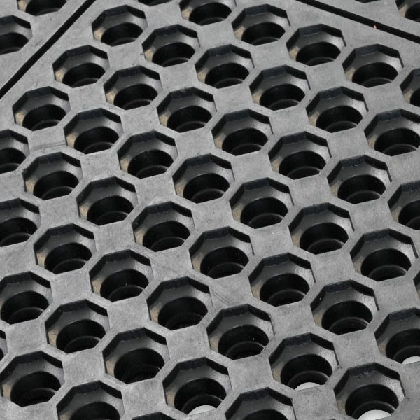 Close-up of the Interlocking Anti-Fatigue Mat, featuring a rugged black rubber surface with repeating hexagonal holes for durability and slip resistance, ideal for industrial or entrance use.