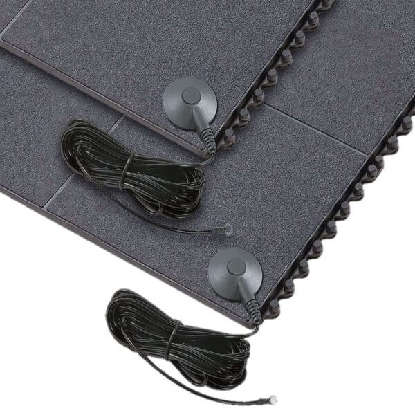 Close-up of two Interlocking Solid Top Gym Mats with textured black surfaces, each featuring a long power lead and round control button, stacked one on top of the other.