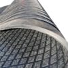 Close-up view of the Diamond Top Stable Mat, featuring a textured black rubber surface with a diamond pattern and a slightly curved transparent edge, set against a white background.