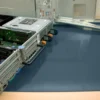 An open computer server sits on an ESD Anti-Static Double Layer Sheet, its metal cover removed to reveal internal circuit boards, data ports, and wiring, ensuring static protection during dismantling.