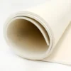 A close-up view of a partially unrolled Food Quality Rubber Sheet in off-white, displayed on a flat white surface.