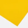 A close-up view of a single Anti-Slip Flat Sheet in bright yellow, positioned diagonally against a plain white background.