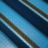 Close-up of blue metal stairs with chequer plate pattern, featuring black Anti-Slip Comfortable Tape along the edge of each step. The angled shot displays several parallel steps.