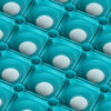 Angled close-up of the Green Grass Mat, showing a repeating pattern of green square cells with circular indents and white centres, creating a geometric and modern look.