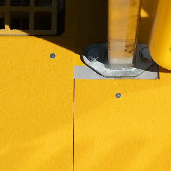 A close-up of the Anti-Slip Flat Sheet shows its bright yellow, textured metal surface with a silver pole and yellow guard rail attached by visible screws. Shadows accentuate the finish.
