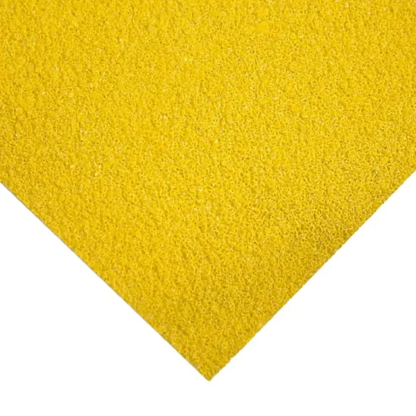 A close-up view of the Anti-Slip Sheet’s rough, grainy yellow surface shown at an angle, with the bottom left corner pointing down—resembling sandpaper or a non-slip mat.