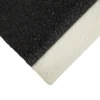 Close-up of the Anti-Slip Stair Tread showing its rough, black textured top surface and smooth, white underside, with the photo angled to highlight the edge.