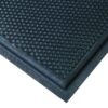 Close-up of the Foam Cushioned Industrial Mat in black, showing its textured surface with raised circular bumps and smooth, bevelled edge, viewed at an angle.