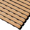 Close-up of Cross-Ribbed PVC Leisure Mat tiles in tan, featuring textured grooves and interlocking slats arranged diagonally on a white background. The gaps between the slats expose the black base structure beneath.