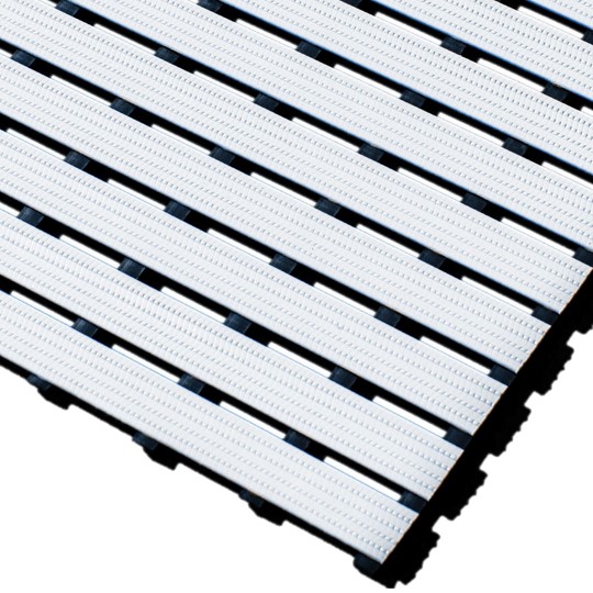 Close-up of Cross-Ribbed PVC Leisure Mat with interlocking white slats and narrow black gaps, shown angled for perspective. The textured surface is designed for drainage and non-slip use.
