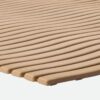 Close-up of the Swimming Pool Mat shows a beige, textured surface with parallel, slightly curved lines and rounded edges, resembling flexible matting.
