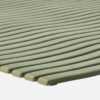 Close-up of the Swimming Pool Mat in light green, featuring evenly spaced diagonal ridges. The mat appears soft, flexible, and textured for comfort and safety.
