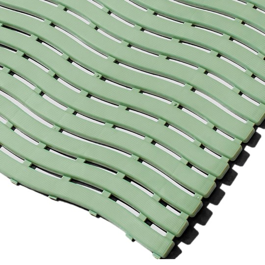 Close-up of Swimming Pool Mat interlocking green tiles featuring a wavy, slotted pattern for drainage. The modular design with overlapping edges is highlighted by the angled arrangement.