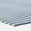 Close-up of the Swimming Pool Mat’s light grey, ribbed surface featuring parallel, slightly curved ridges arranged side by side.