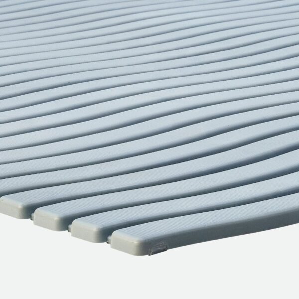 Close-up of the Swimming Pool Mat’s light grey, ribbed surface featuring parallel, slightly curved ridges arranged side by side.