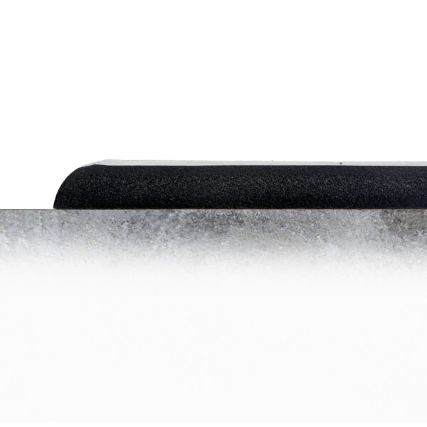 The Comfort Plus Anti-Fatigue Mat, rectangular and black, sits on a grey concrete floor with a simple white background for a minimal, modern look.