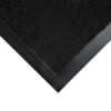 A close-up of the corner of a Plush Entrance Mat, featuring a dark, textured surface and a smooth black rubber border.