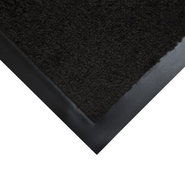 A close-up of the corner of a Plush Entrance Mat, featuring a dark, textured surface and a smooth black rubber border.