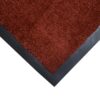 Close-up view of the corner of the Plush Entrance Mat, featuring red shaggy fibres with a black border, displayed on a white background.