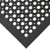 Close-up of the Large Front Door Mat Bundle’s corner, showing black rubber with circular holes in a repeating pattern and bevelled edges for a smooth floor transition.
