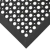 Close-up of the Large Front Door Mat Bundle in black rubber, featuring a pattern of large and small circular holes. The image captures the corner with its textured, layered border and durable design.