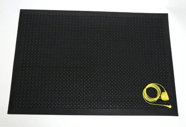 The Bubble Top ESD Mat is a large black rubber mat with a textured surface, shown with a coiled yellow cable and plug on the lower right corner against a white background.