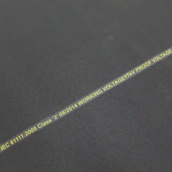 Close-up of Electrical Safety Matting in black, featuring yellow text: IEC 61111:2009 Class - 2 08/2014 WORKING VOLTAGE: 17kV PROOF VOLTAGE.