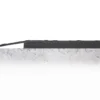 The Senso Dial Mat ESD, a black rubber strip, is fitted to the edge of a flat, grey, textured concrete surface and extends beyond it. The background is white and minimalist.