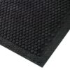 Close-up of the Dirt Remover Mat, featuring black rubber with raised circular bumps and a textured border, viewed from an angle.