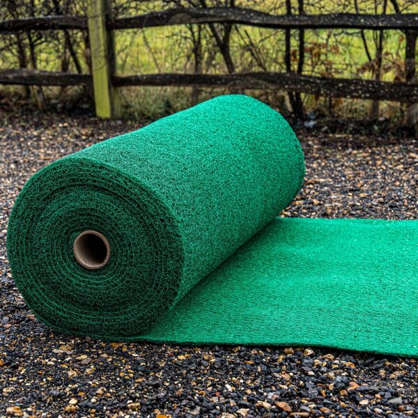 A large roll of Heavy-Duty PVC Vinyl is unrolled outdoors on gravel, with a wooden fence and grassy area visible in the background.