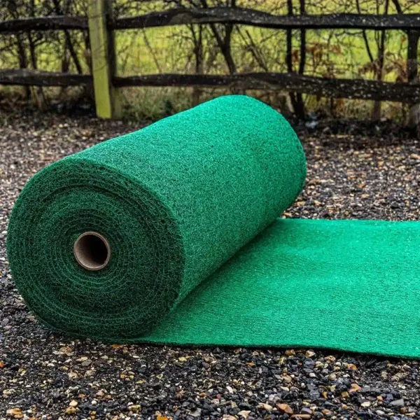 A large Heavy-Duty PVC Vinyl Roll unrolled on a gravel surface outdoors, with a wooden fence and greenery visible in the background.