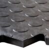 Close-up of the Circular Stud Interlocking Tile, a black rubber flooring mat featuring a raised circular stud pattern and zigzag cut edge detail.