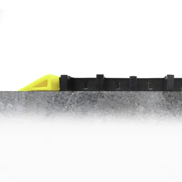The Safety Cross-Ribbed Mat, in black and yellow, is installed on a concrete surface and viewed from the side against a plain white background.