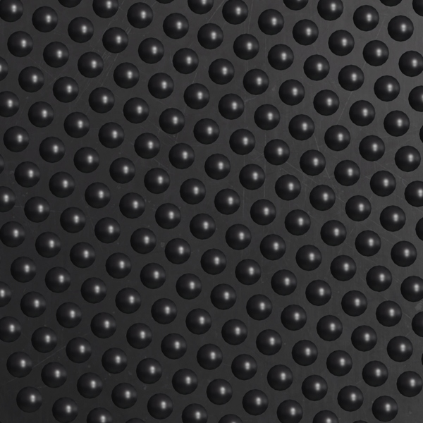 Close-up of the Interlocking Bubble Top Stable Mat’s black textured surface featuring evenly spaced, raised round bumps that catch the light, creating subtle highlights and shadows.