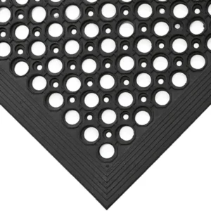 A close-up of the Fine Ribbed Matting Roll in black, featuring evenly spaced round holes for a non-slip surface. The image highlights the mat's corner with its layered, textured edges.