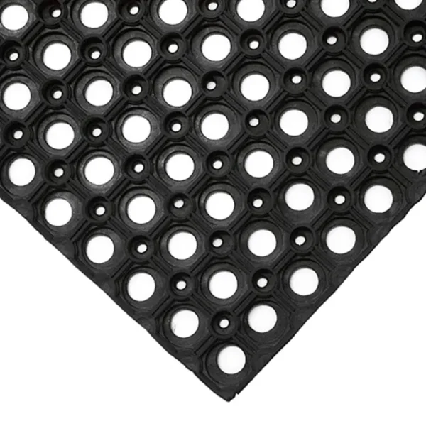 The Fine Ribbed Matting Roll, shown from an angled corner view, is a black rubber mat featuring a textured, grid-like design for slip resistance and drainage. Large and small circular holes are patterned across the surface.