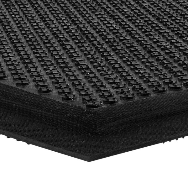 Close-up of the Foam Cushioned Industrial Mat in black, highlighting its textured surface with raised circular bumps arranged in a grid and showing the mat’s edge and thickness.
