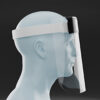 A translucent mannequin head in profile displays the Disposable Face Shield, featuring a clear plastic visor, white headband, and black fastening, set against a dark background.