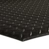 Close-up of the Comfort Plus Anti-Fatigue Mat in black rubber, featuring a raised diamond pattern texture photographed at an angle to highlight its repeating three-dimensional surface design.