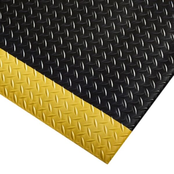 The Comfort Plus Anti-Fatigue Mat, shown from an angled top view, features a black diamond plate surface for grip and a yellow bevelled edge that acts as a high-visibility safety border.