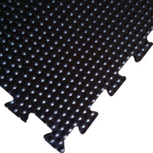 Interlocking rubber tile matt|amoebic top stable mat underside|close up of a bubble top stable mat